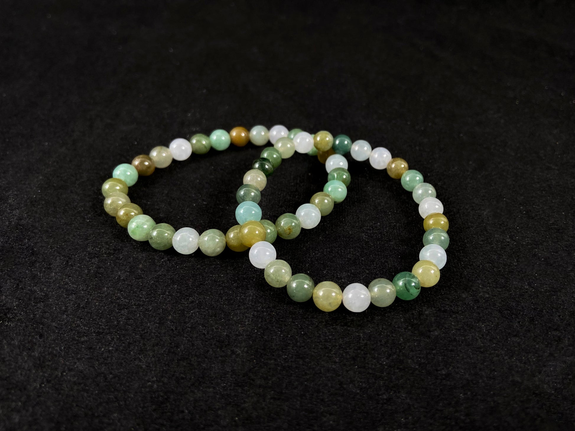 Two beaded bracelets on a black background