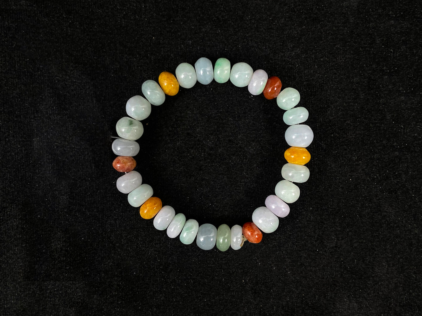 Beaded bracelet with multicolored beads on a black background