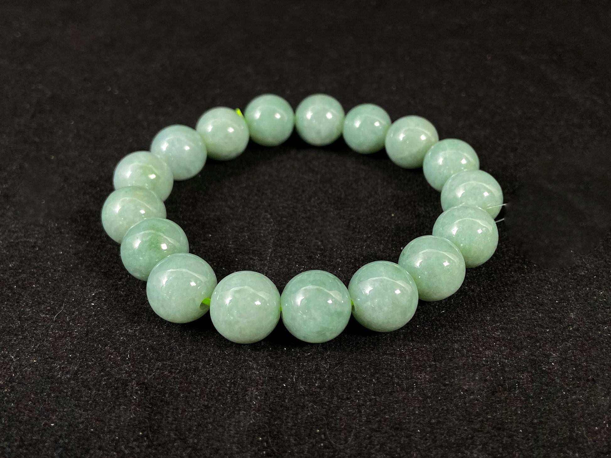 A jade bead strand with a blue base color.