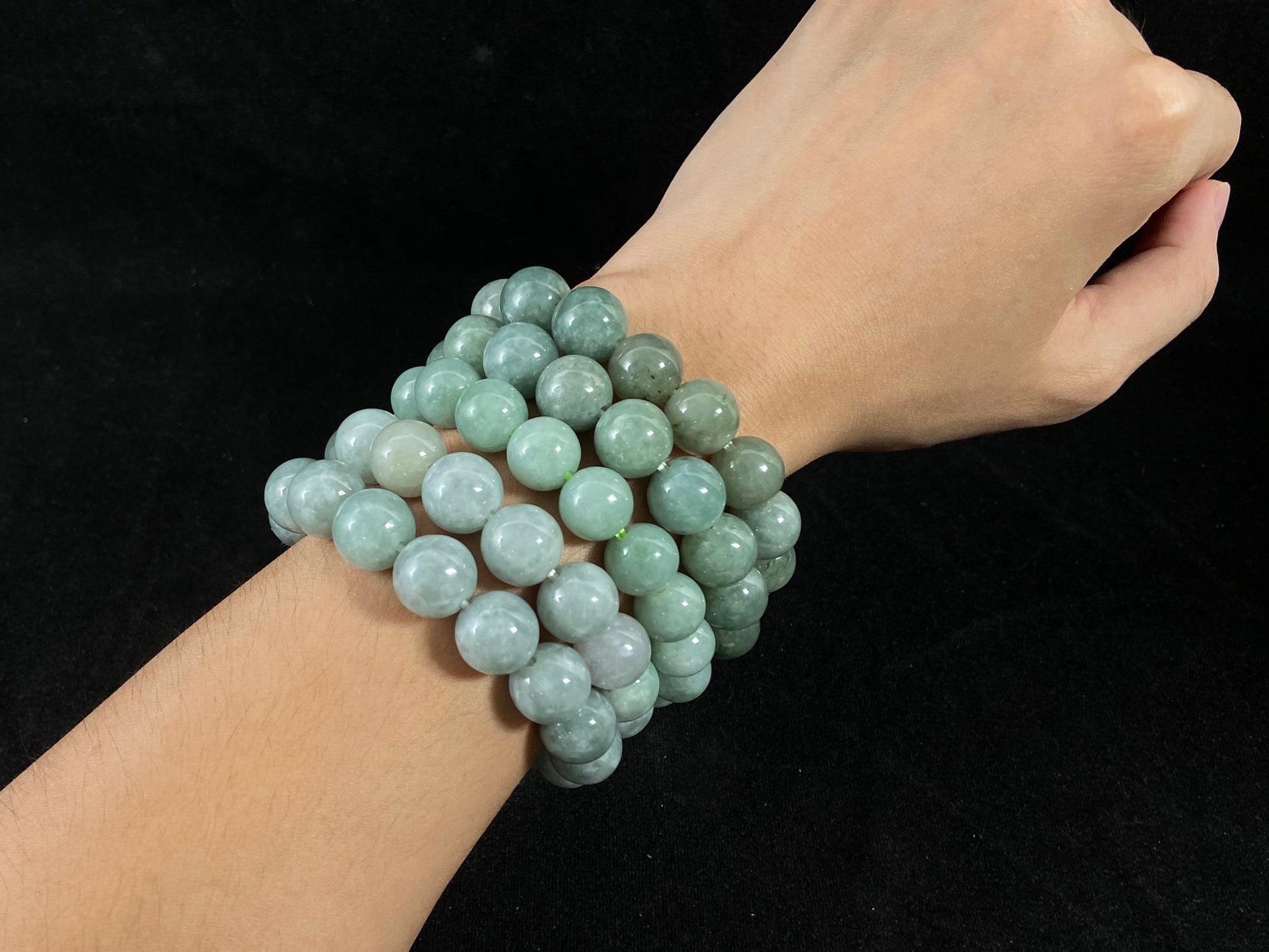 A jade bead strand with a blue base color.