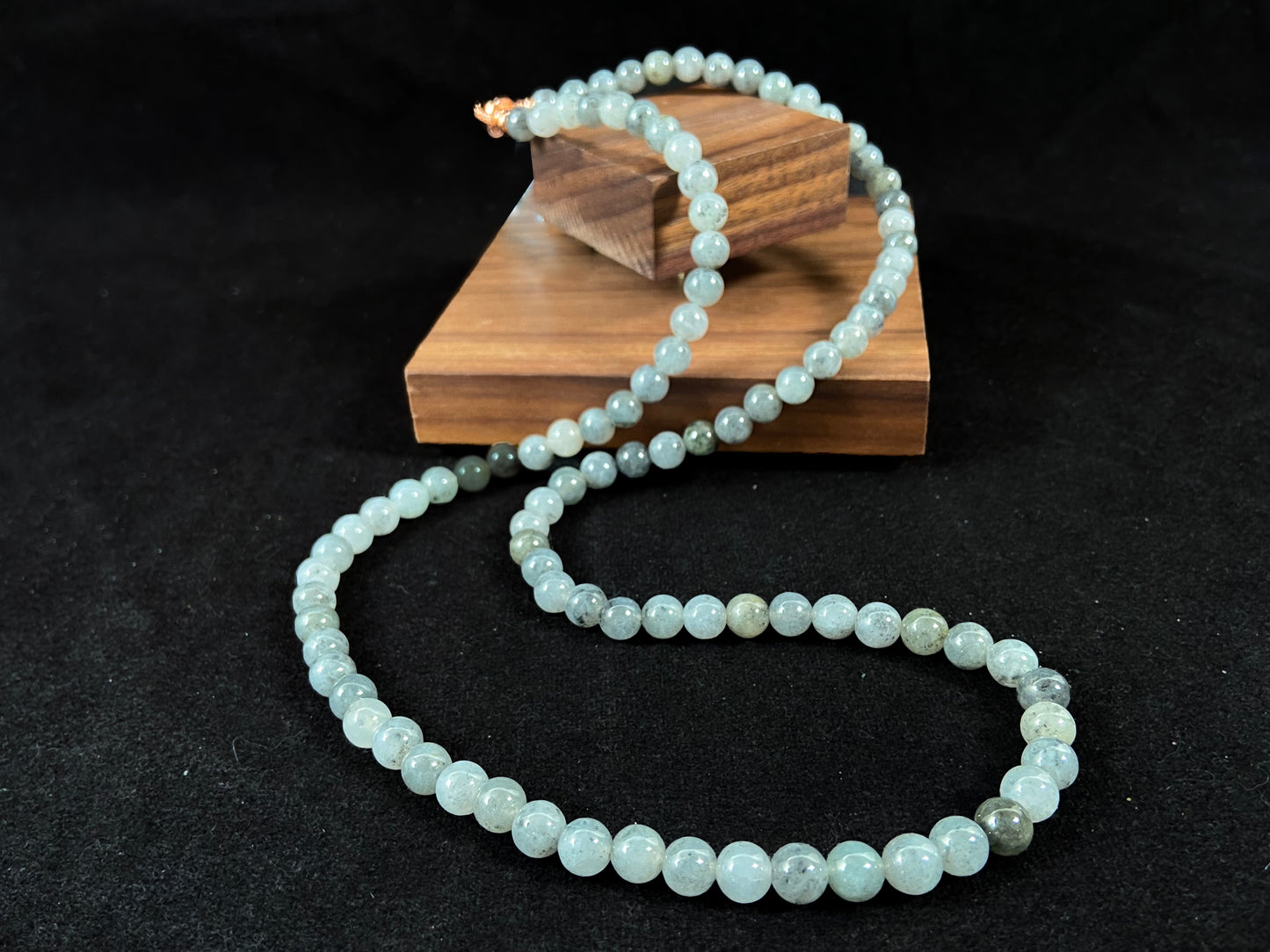 Semi transparent jade beads with unique gray accents, deep green stones, and alloy clasp.