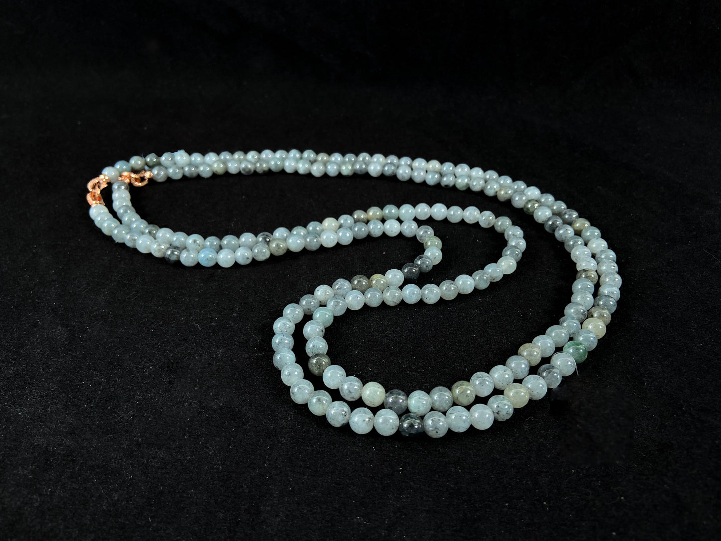 Semi transparent jade beads with unique gray accents, deep green stones, and alloy clasp.