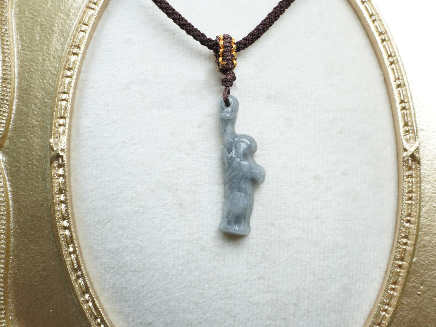 A sleek ssh toned statue of liberty jadeite pendant.