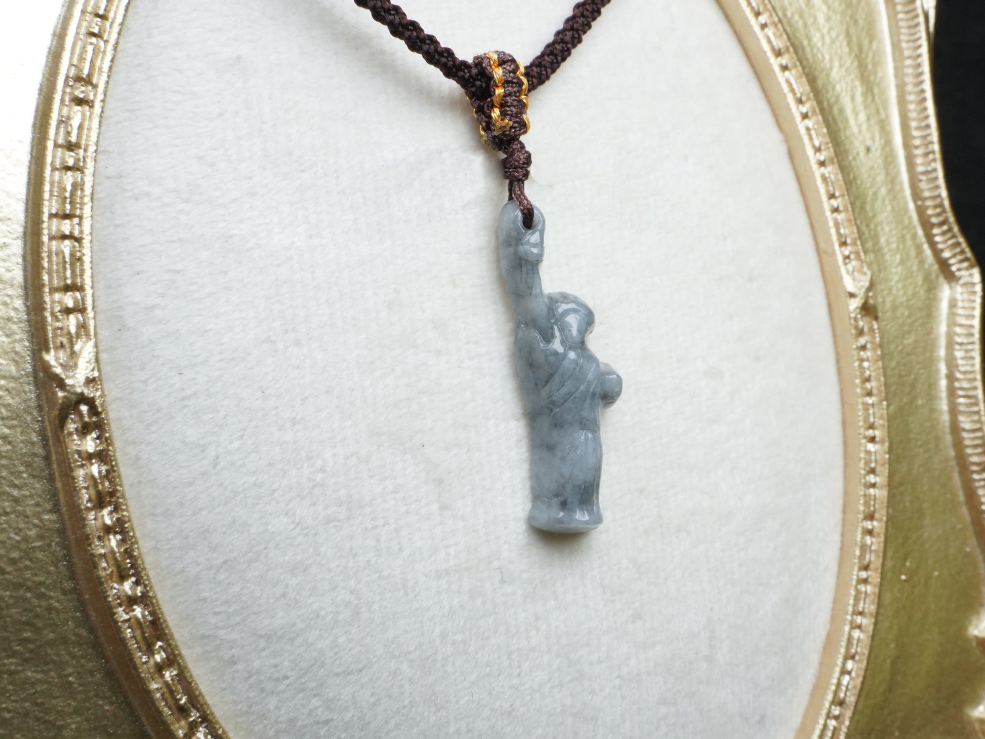 A sleek ssh toned statue of liberty jadeite pendant.