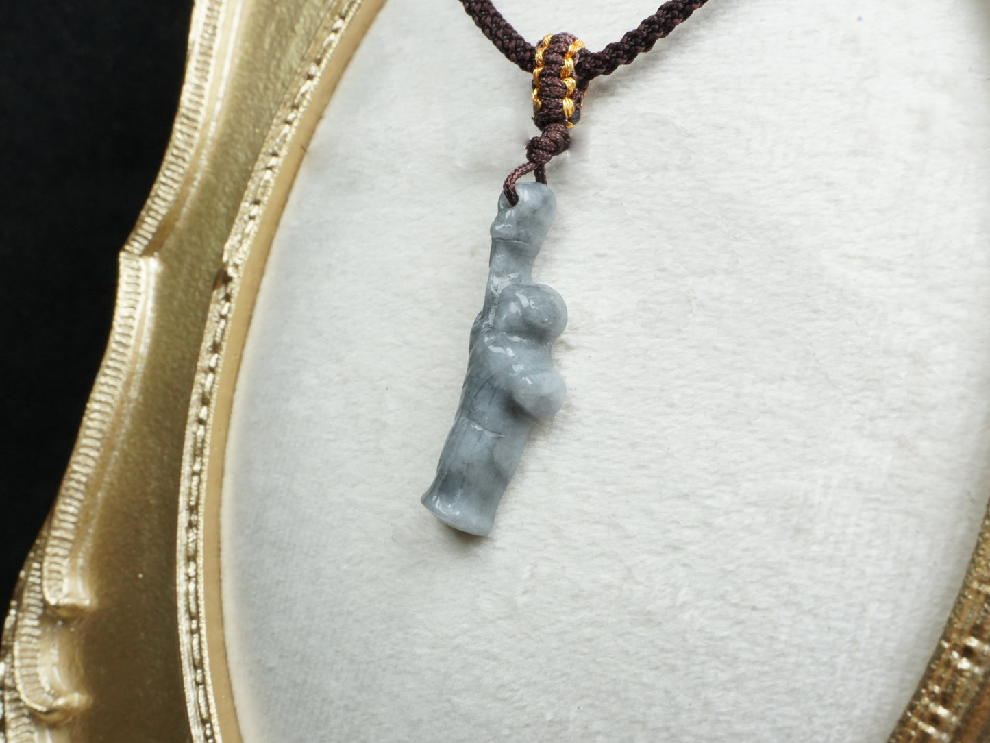 A sleek ssh toned statue of liberty jadeite pendant.