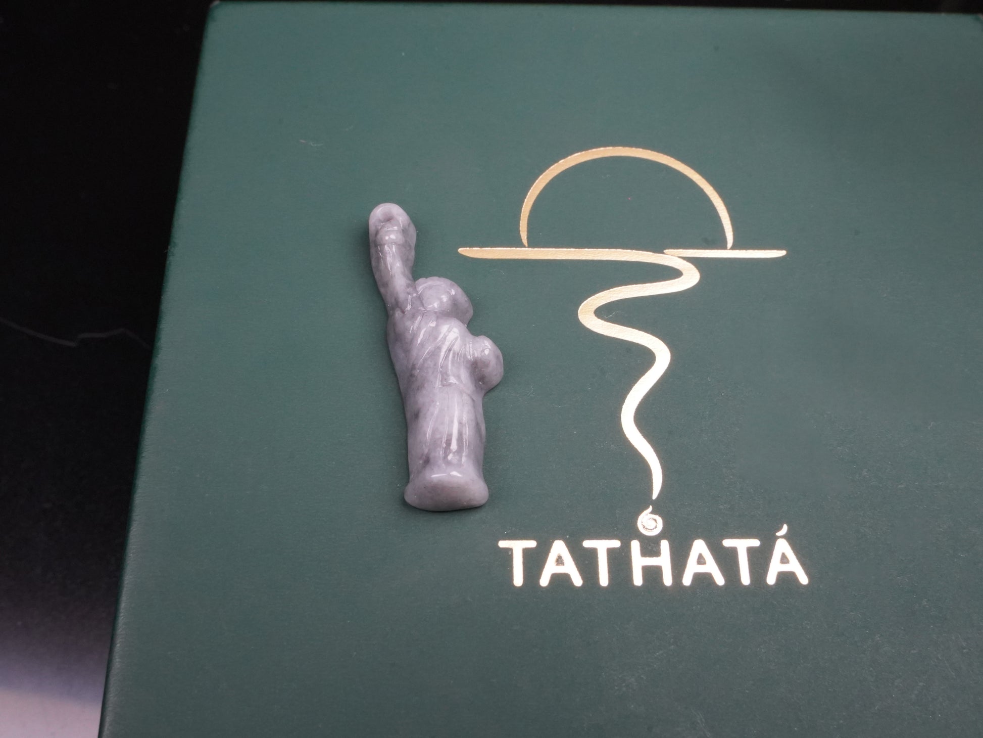 A sleek ssh toned statue of liberty jadeite pendant.