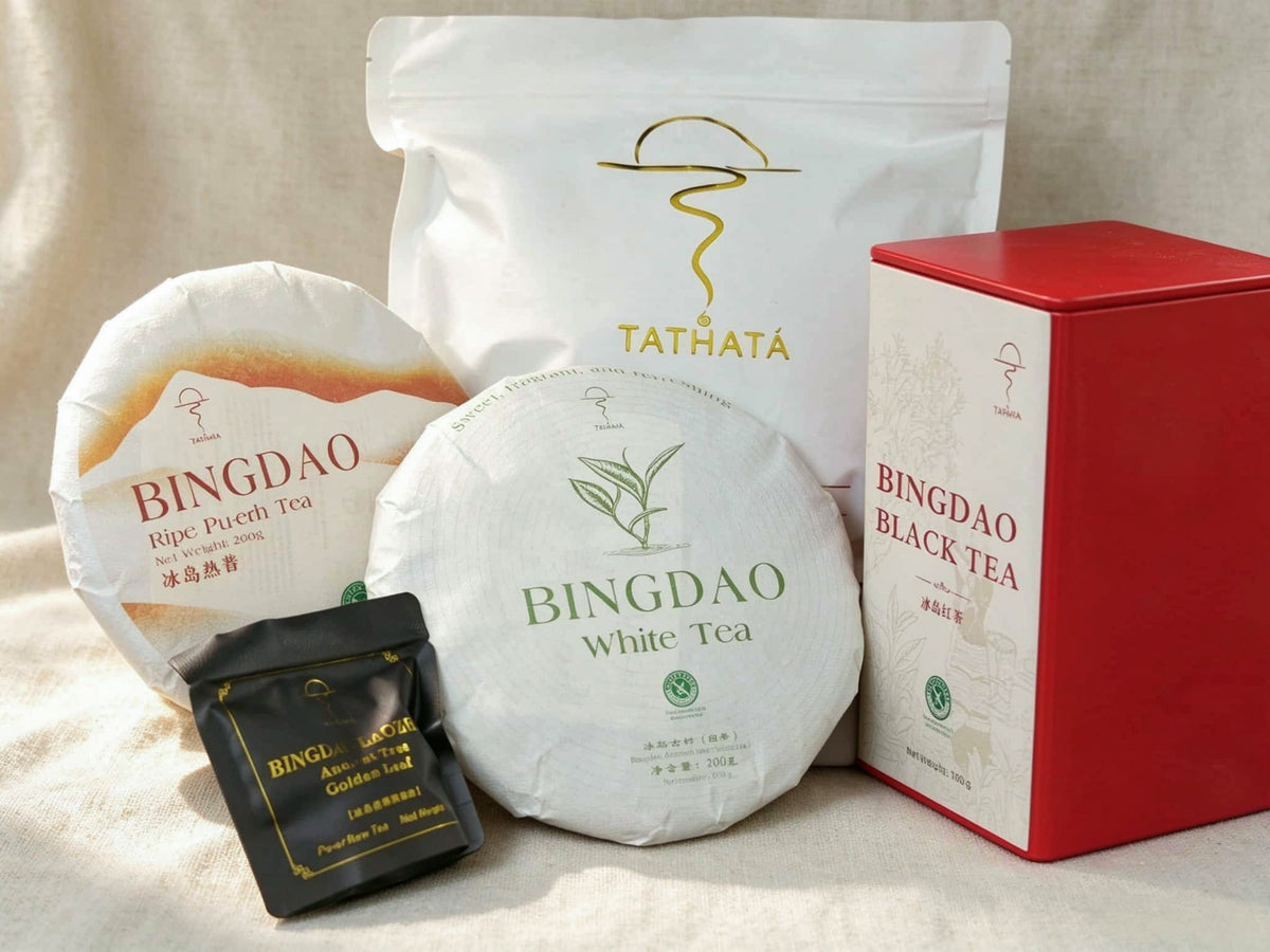 This image showcases the TATHATA Yunnan Bingdao Premium Tea Gift Set: Bingdao Ripe Pu-erh tea cake, Bingdao white tea cake, Bingdao black tea (red tin), and "Golden Leaf" raw Pu-erh tea (individual sachets).
