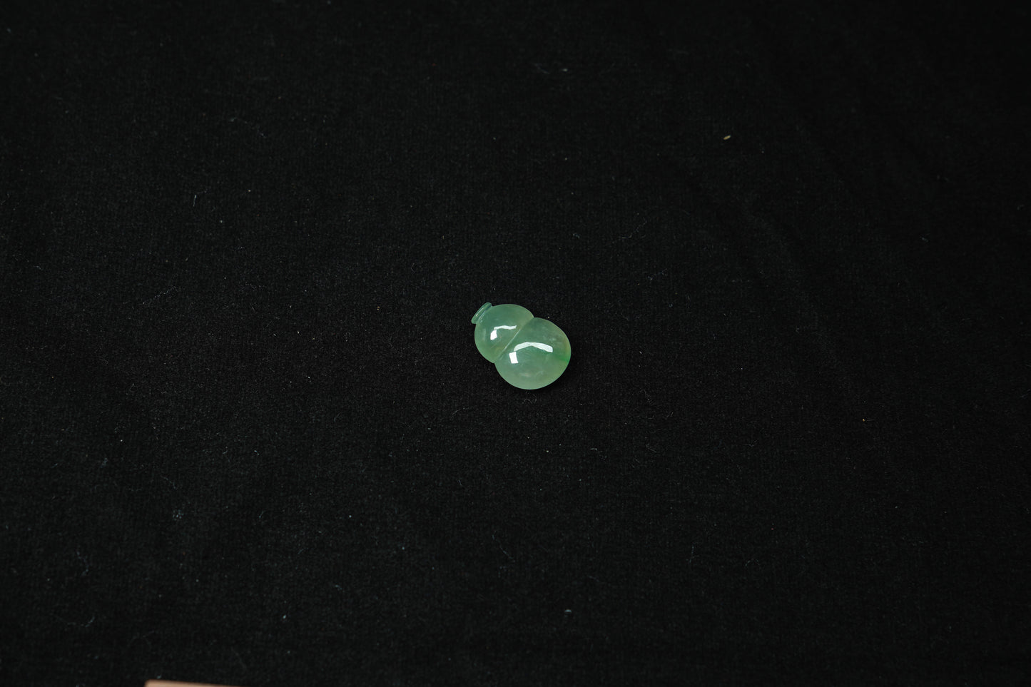 Small green object on a black background