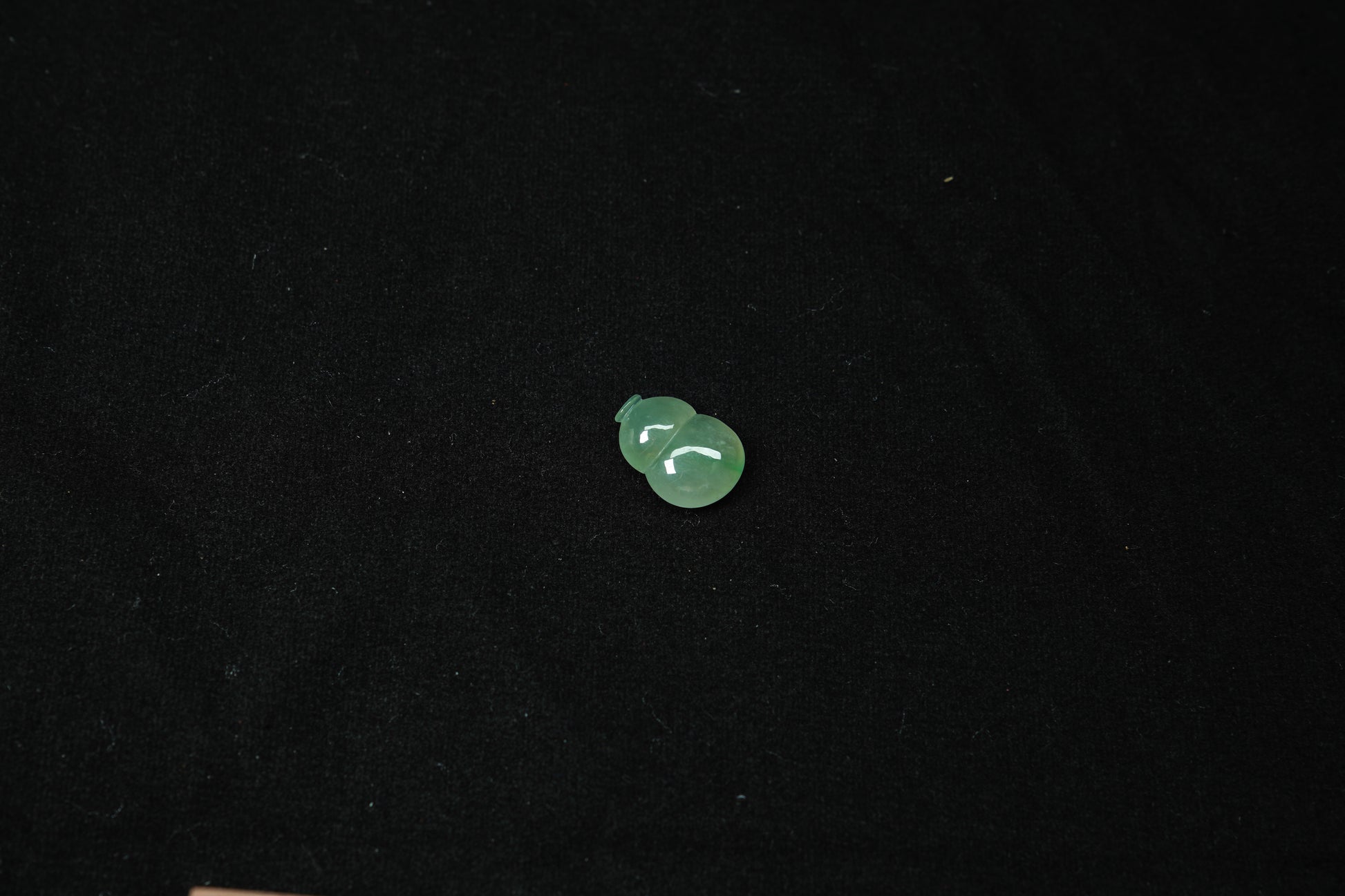 Small green object on a black background