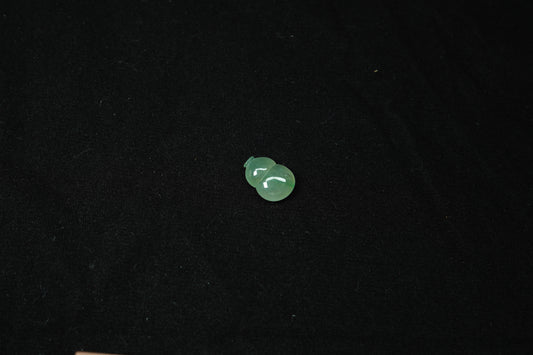 Small green object on a black background