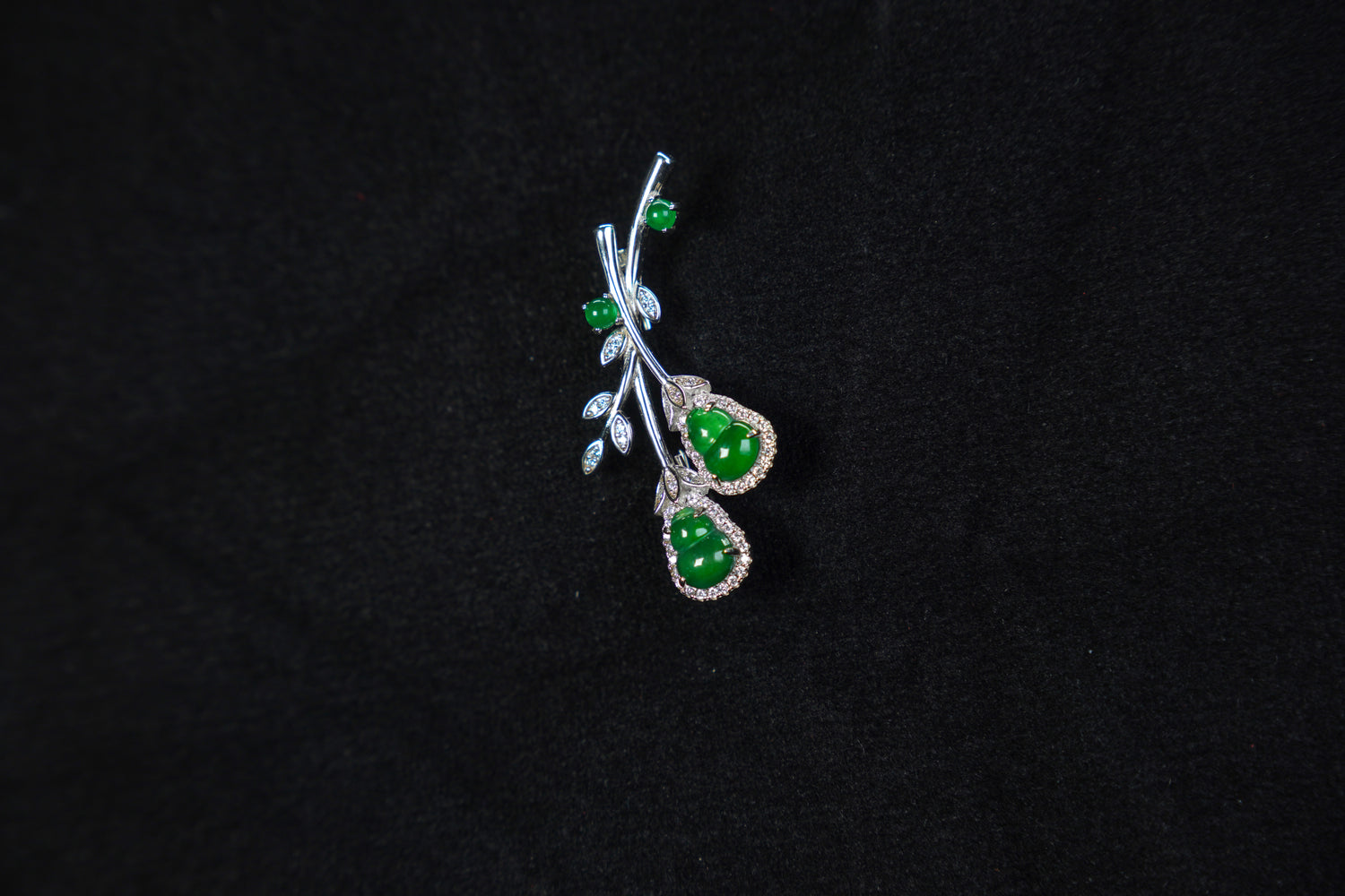 Jewelry with green stones on a black background