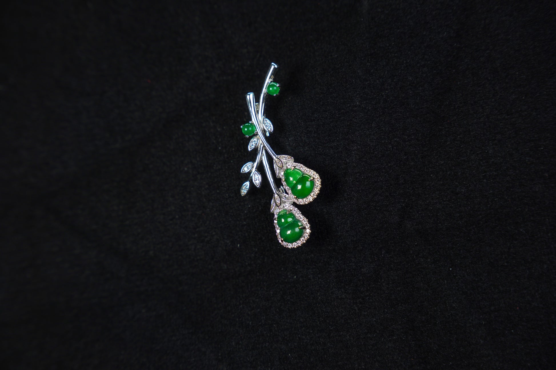 Jewelry with green stones on a black background