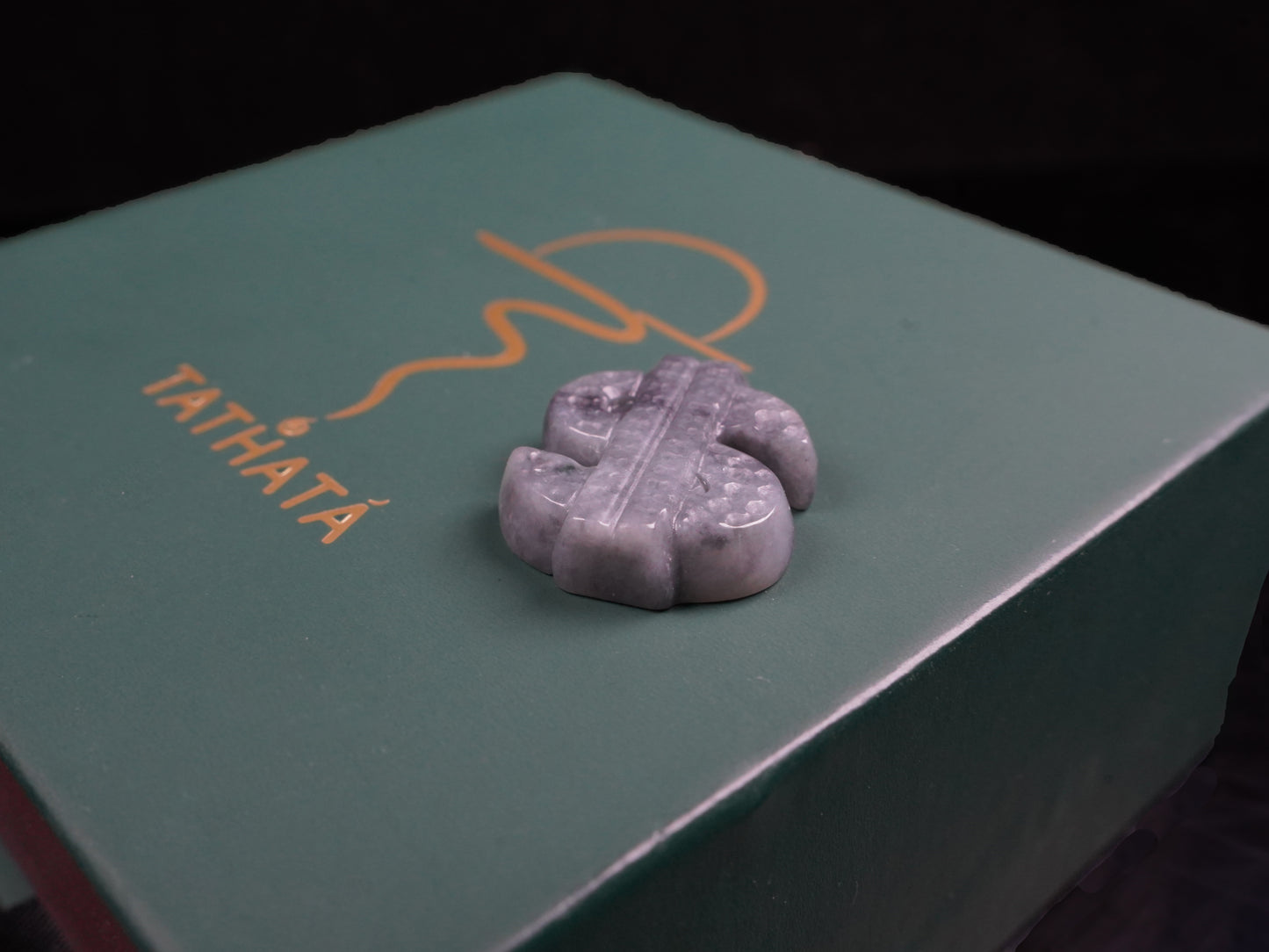 A grey prosperity dollar charm loose jadeite.