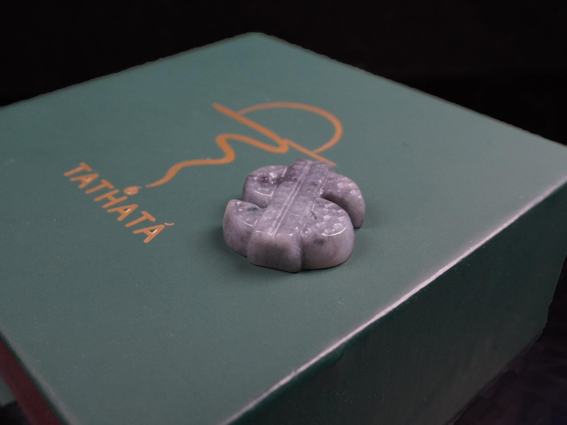 A grey prosperity dollar charm loose jadeite.