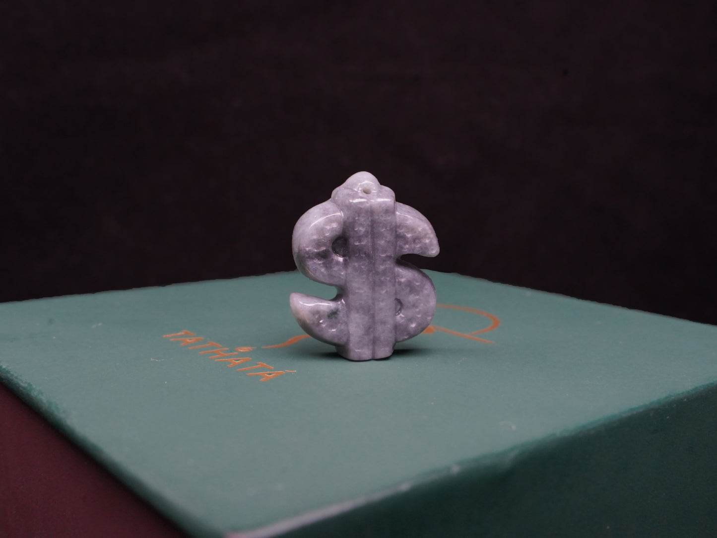 A grey prosperity dollar charm loose jadeite.