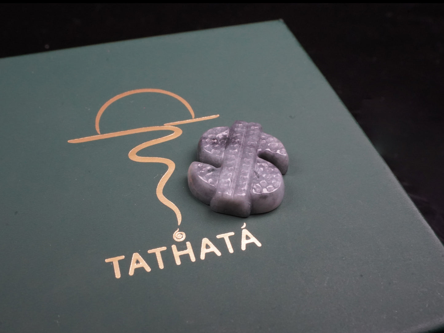 A grey prosperity dollar charm loose jadeite.