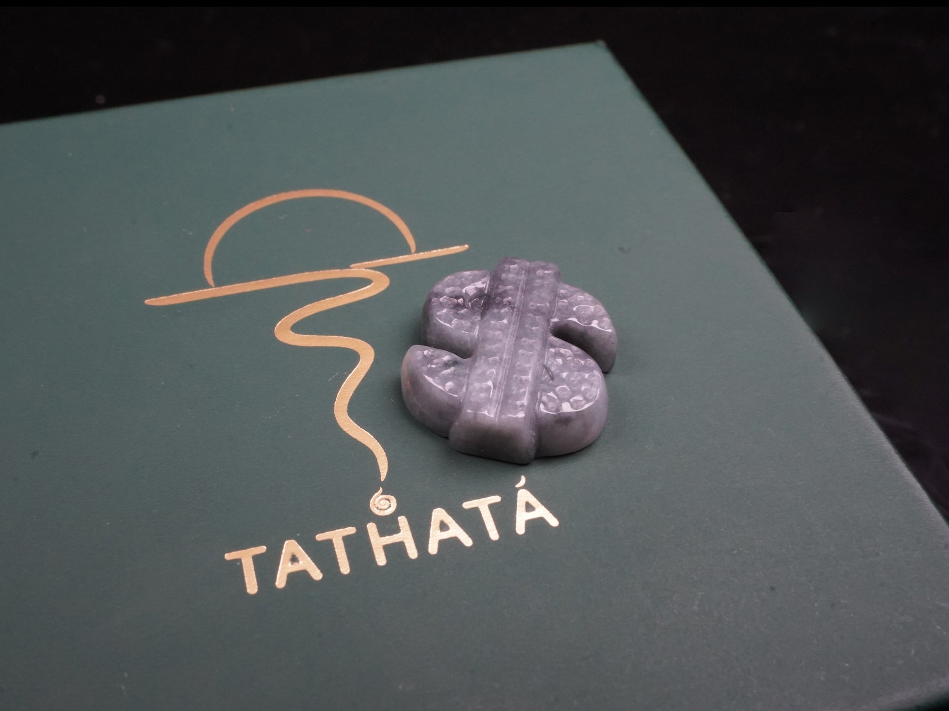 A grey prosperity dollar charm loose jadeite.