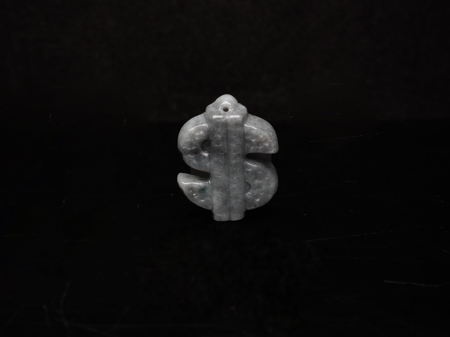 A grey prosperity dollar charm loose jadeite.