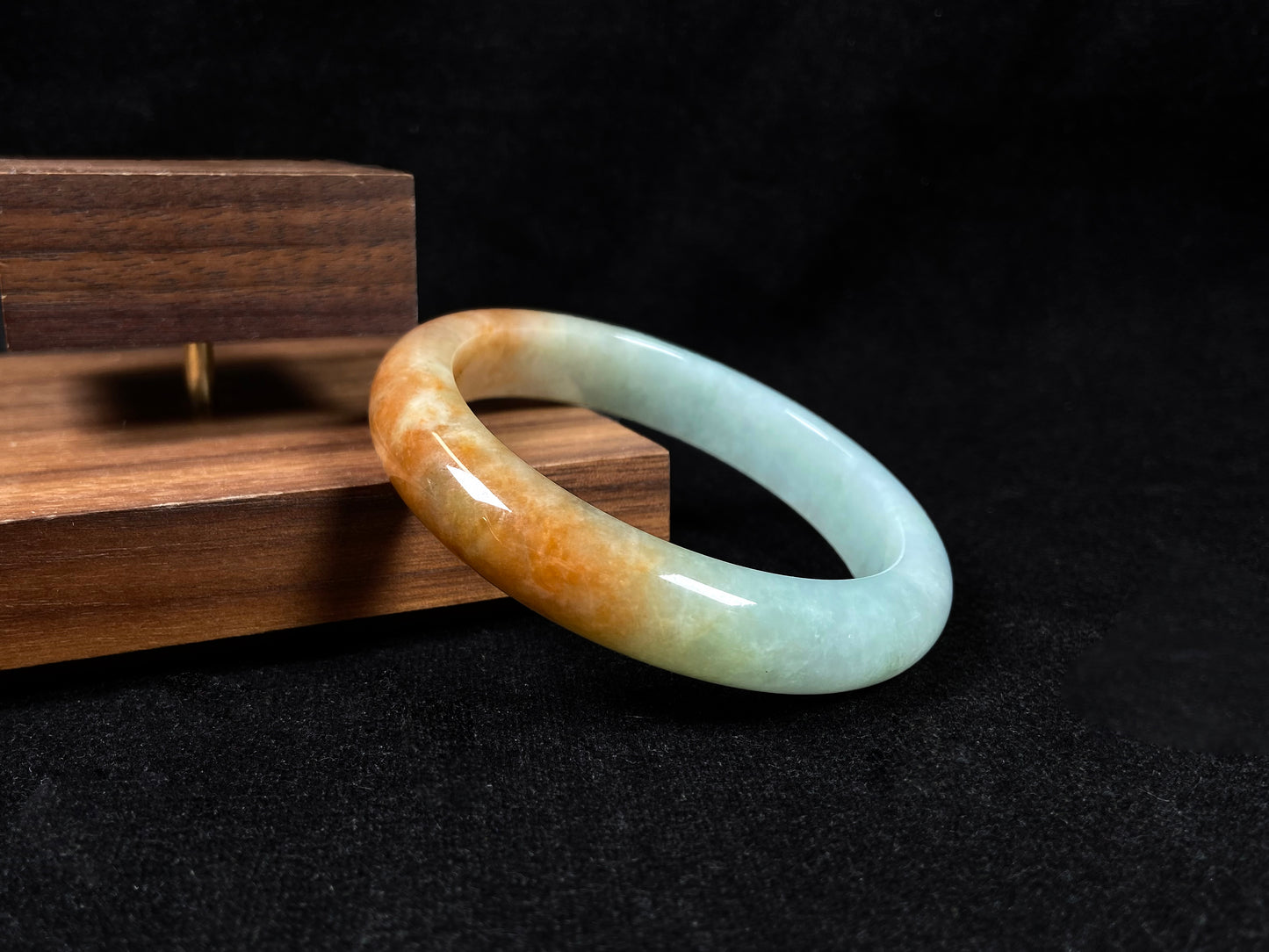 A jadeite bangle where soft mint green gently transitions into warm honey amber.