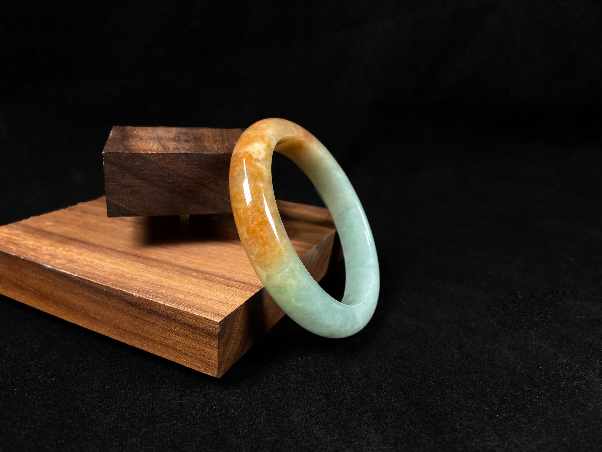 A jadeite bangle where soft mint green gently transitions into warm honey amber.