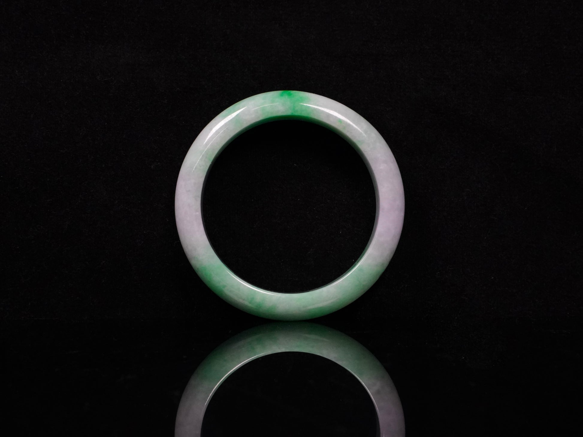 A lilac and viridescent bi-color gradient  jadeite bangle.