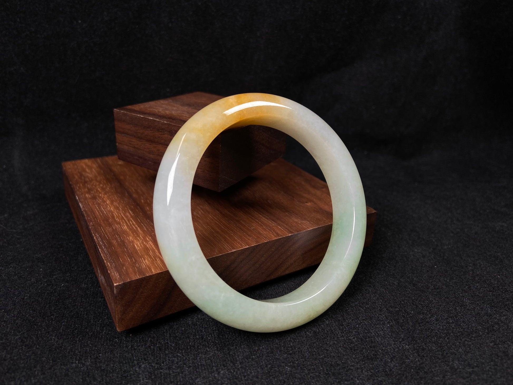 A light green jadeite bangle with a bold splash of gold.