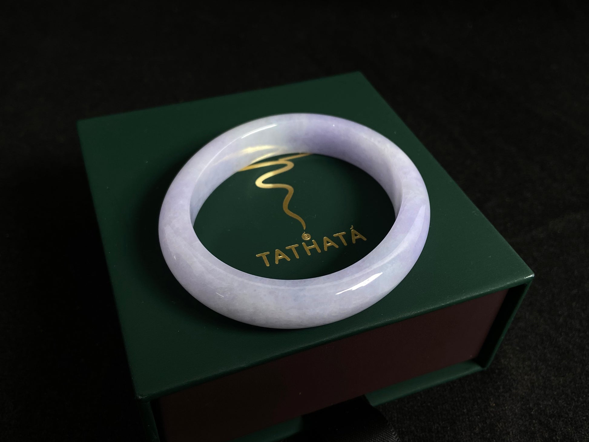 This elegant jade bangle showcases a unique white purple hue with delicate color blending.