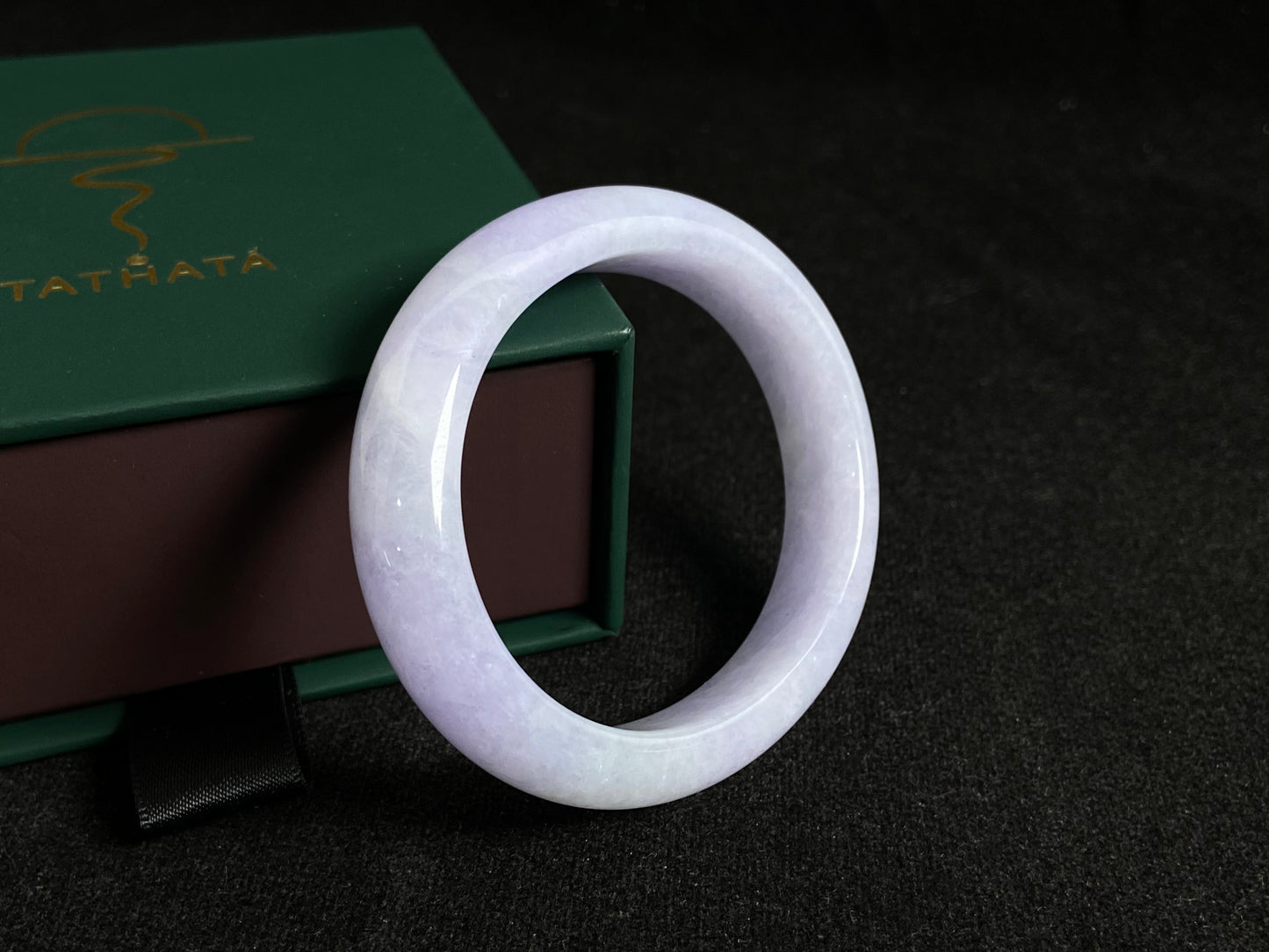This elegant jade bangle showcases a unique white purple hue with delicate color blending.