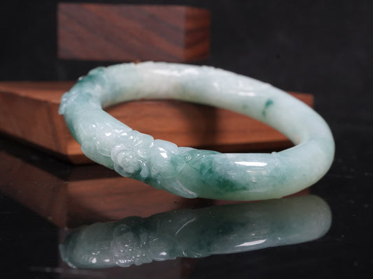 Milky white with blue green veins and floral carvings Jadeite Bangle.