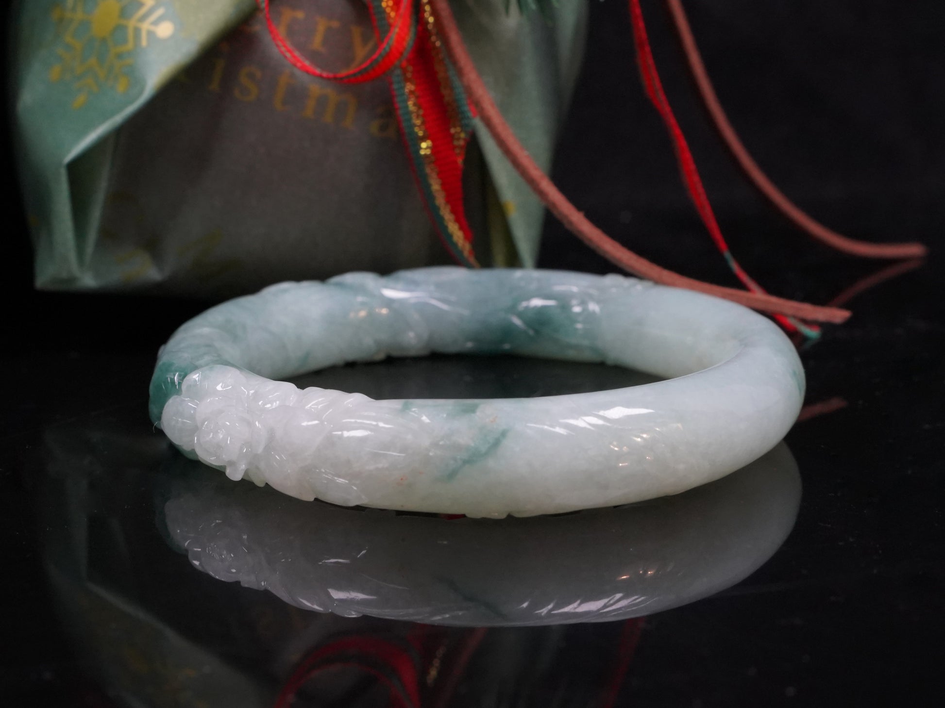Milky white with blue green veins and floral carvings Jadeite Bangle.