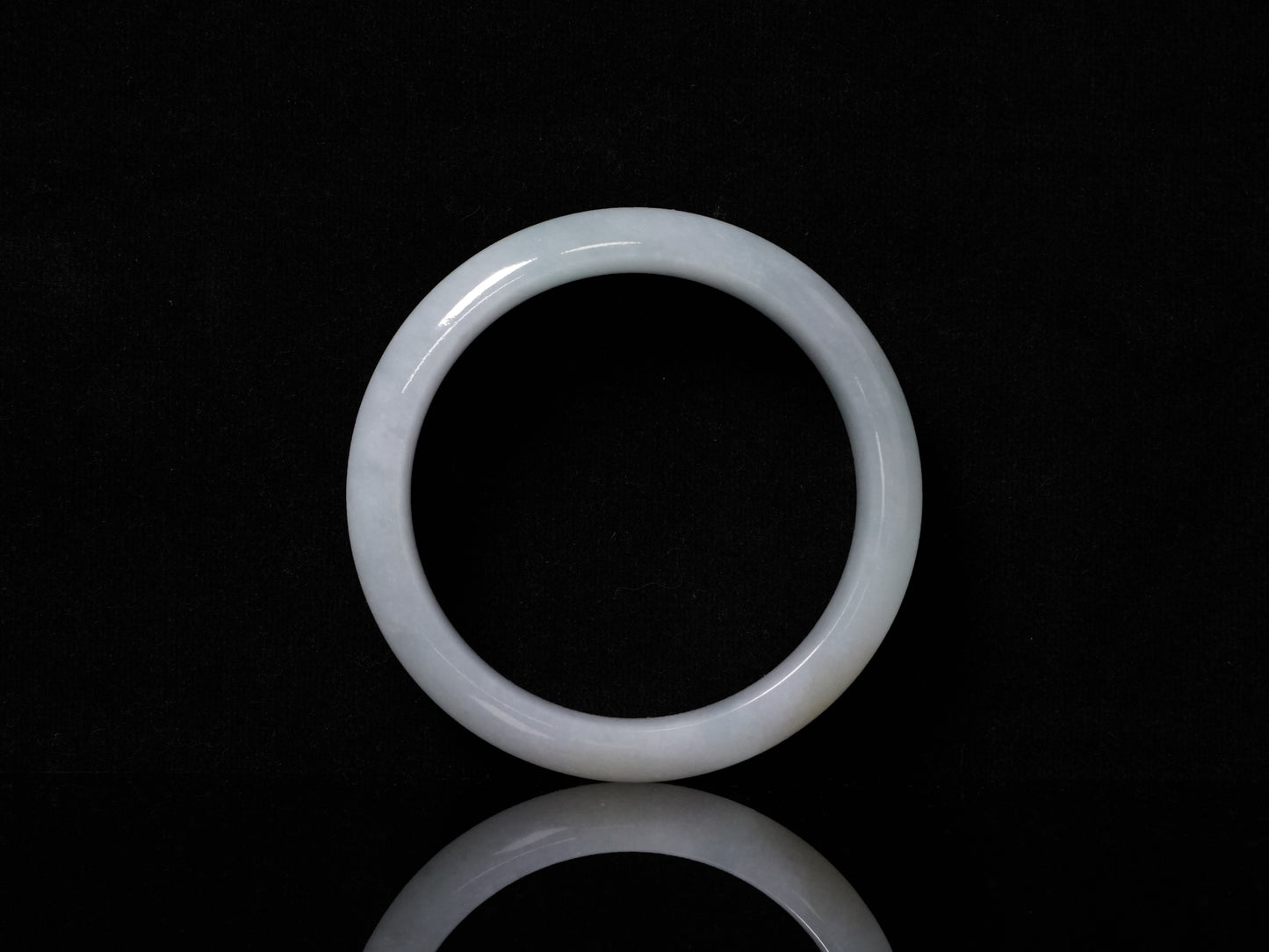 A pale frosty jadeite bangle.