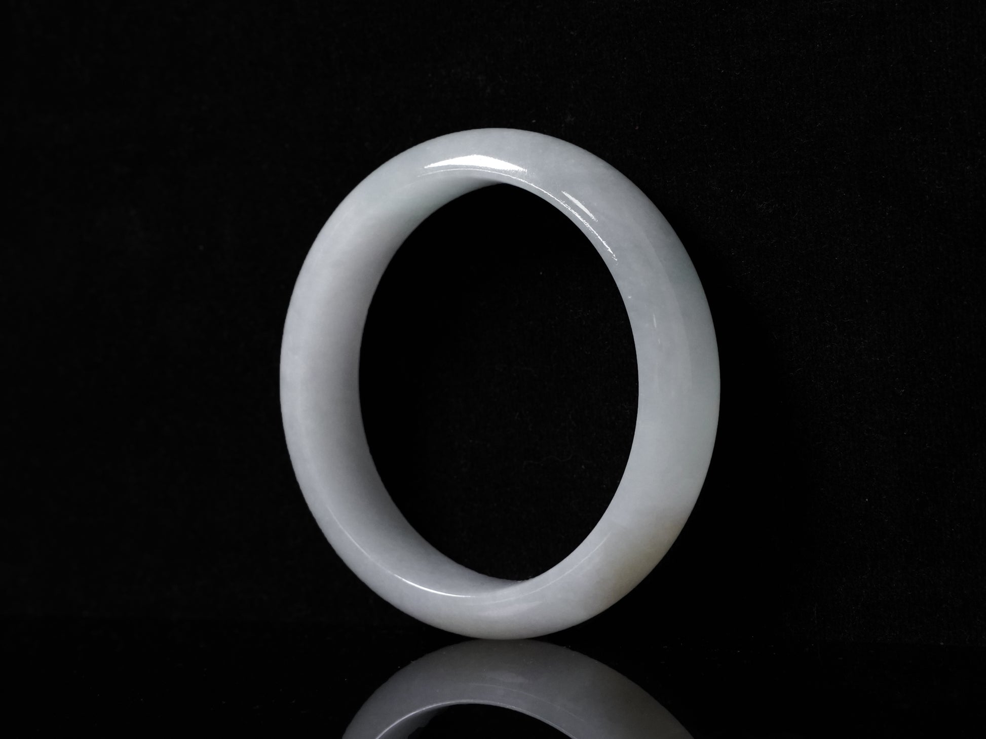 A pale frosty jadeite bangle.