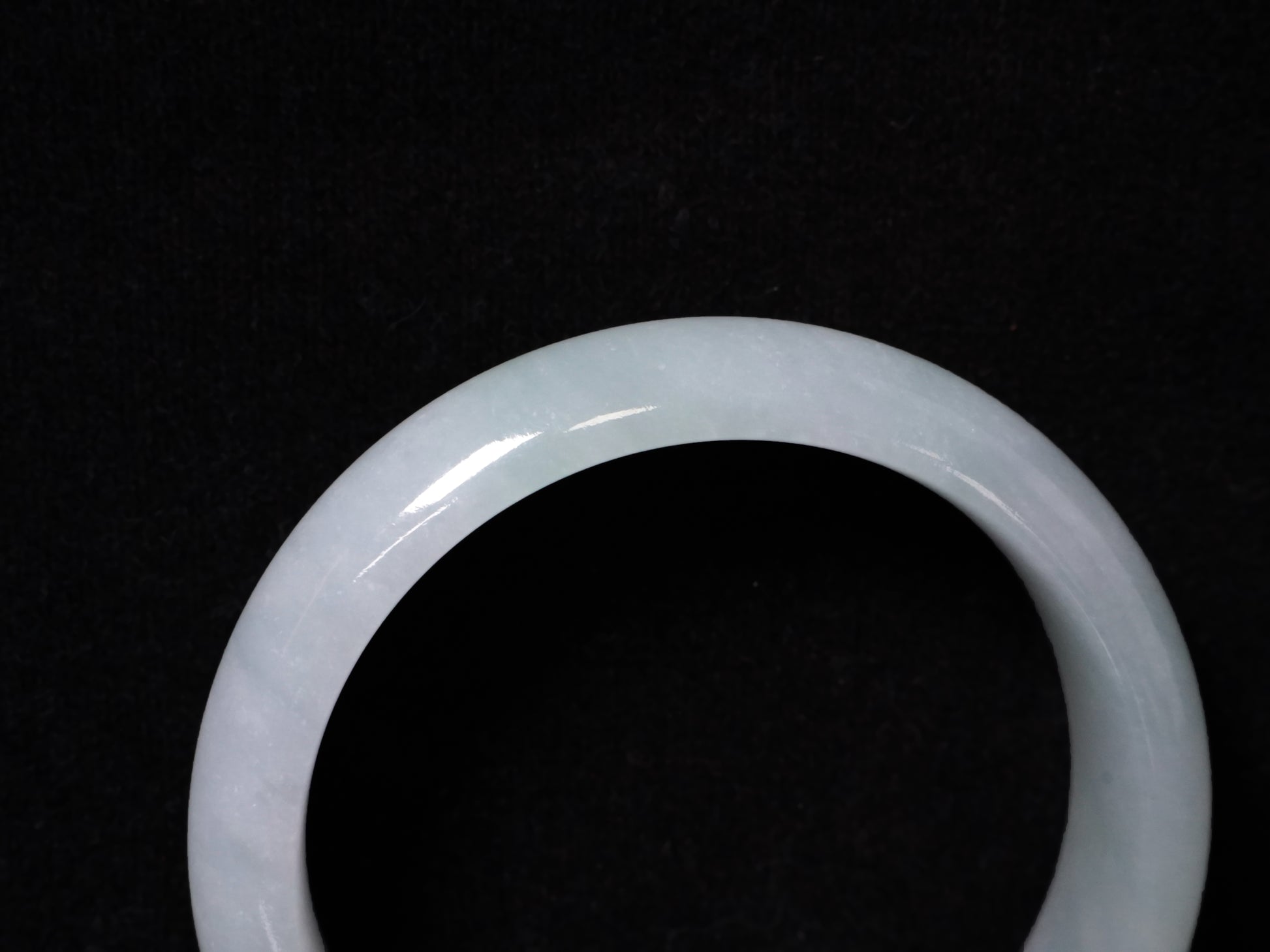 A pale frosty jadeite bangle.
