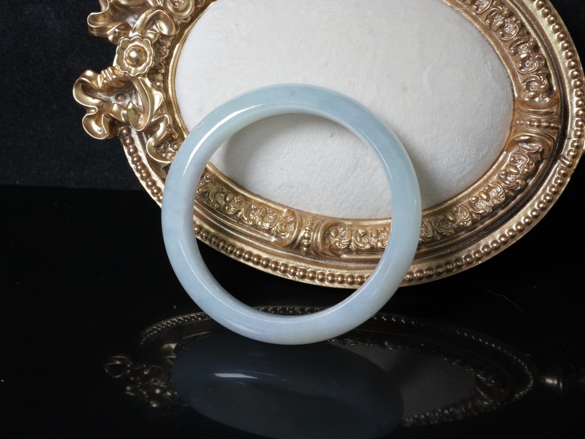 A pale frosty jadeite bangle.