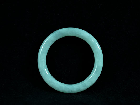 Light blue jade bracelet on a black background
