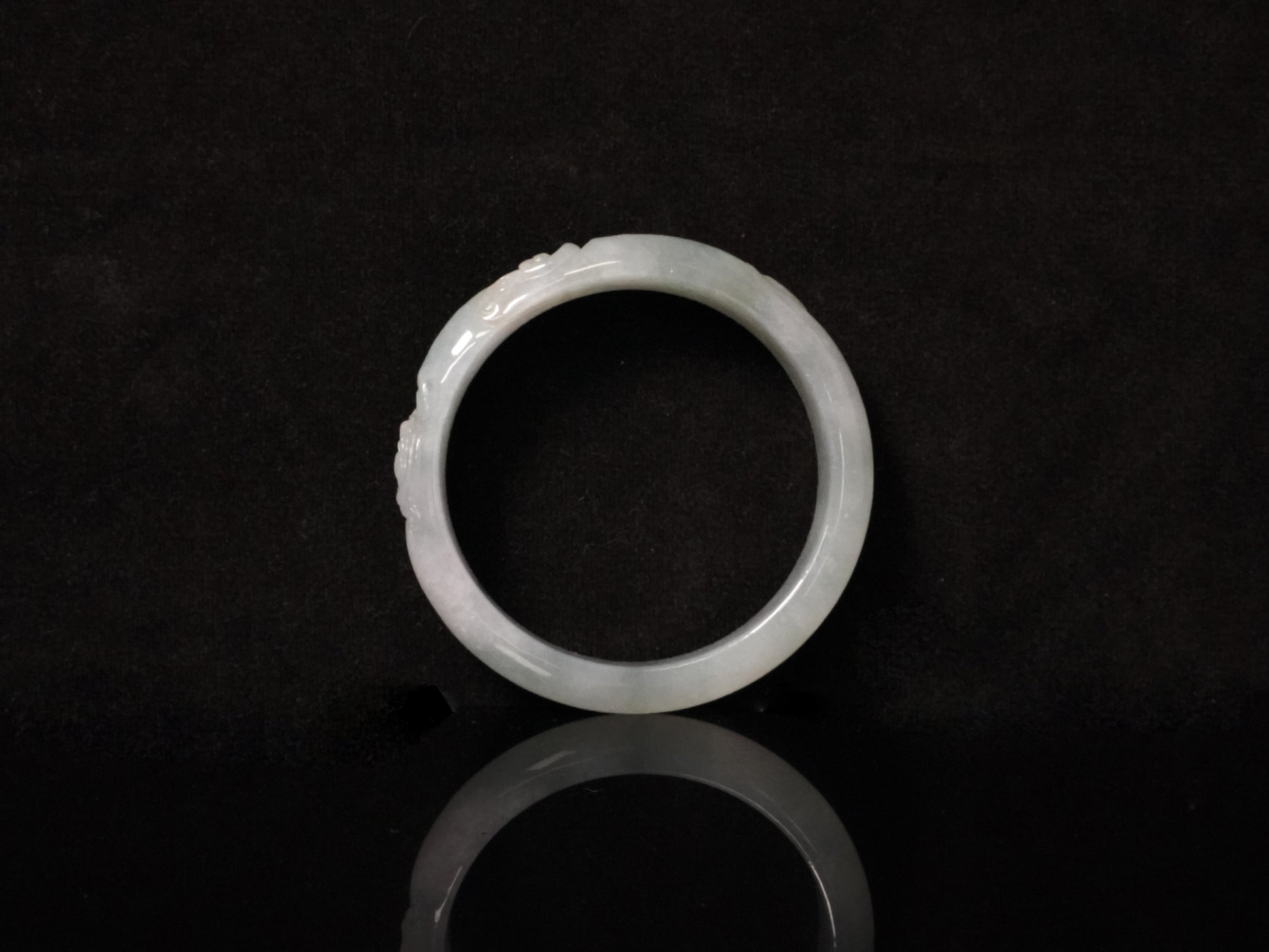 A ivory mist carving jadeite bangle.