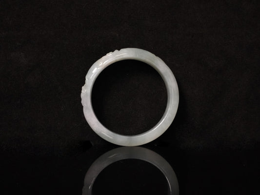 A ivory mist carving jadeite bangle.