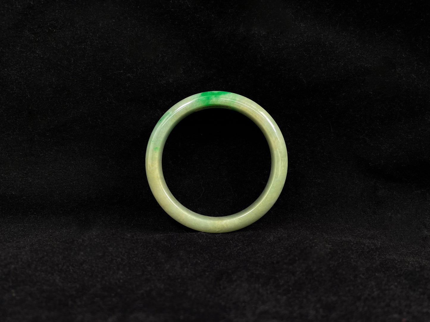 A yellow jadeite bangle with a touch of vibrant green.