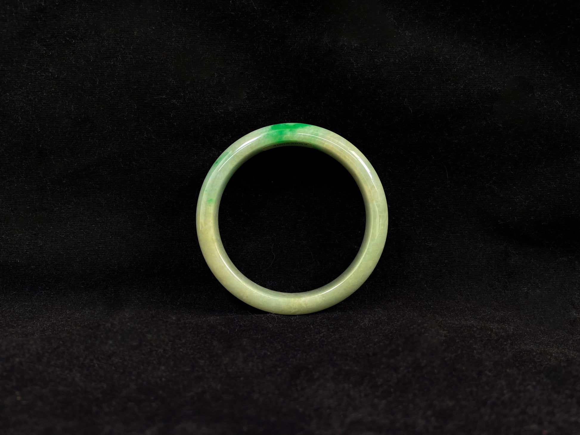 A yellow jadeite bangle with a touch of vibrant green.