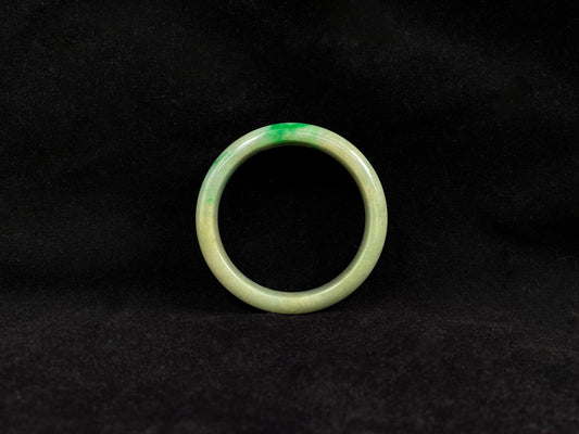A yellow jadeite bangle with a touch of vibrant green.