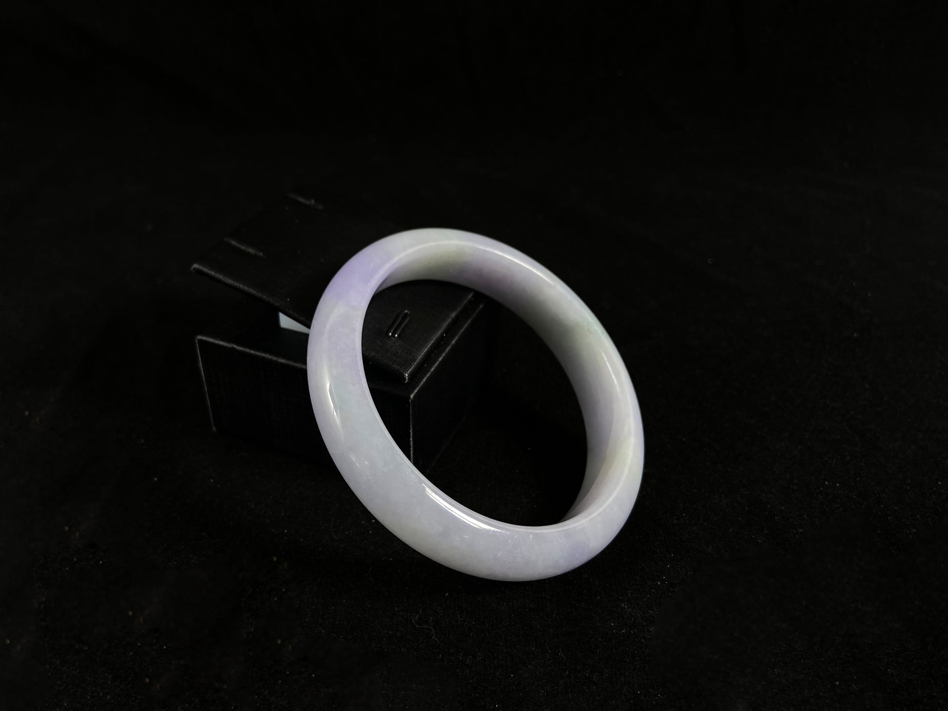 White jade ring on a black background