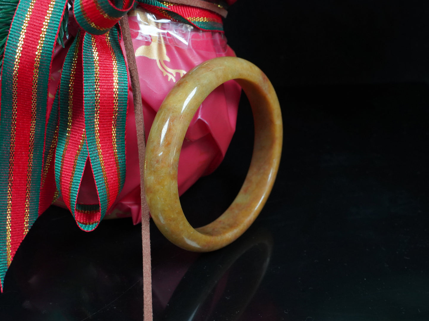 A auburn tinged golden caramel jadeite bangle.