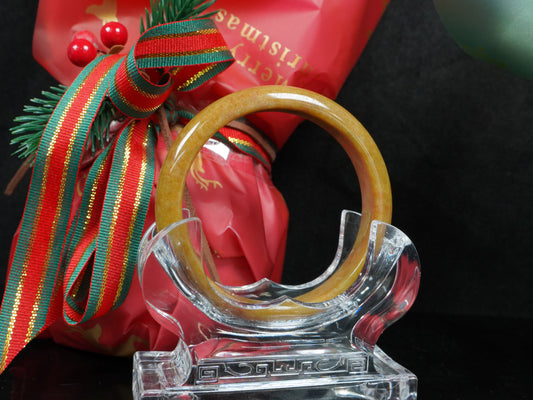  A auburn tinged golden caramel jadeite bangle.