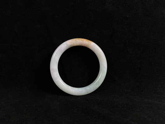 White jade ring jadeite bangle on a black background
