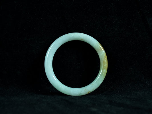 Green jade ring on a black background