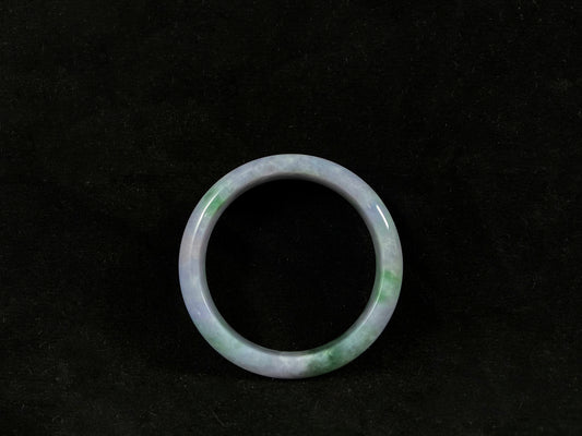 Green jade ring on a black background