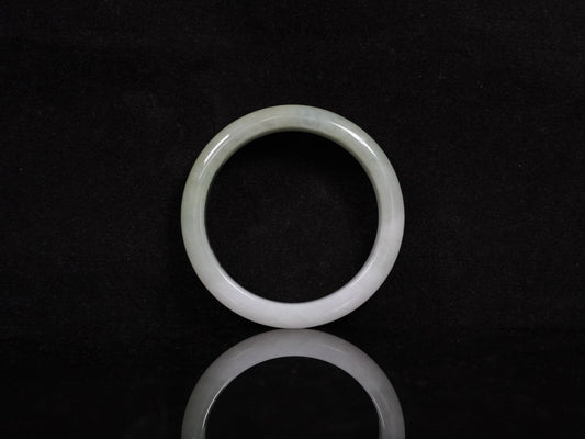 A half white half pale green dual tone  jadeite bangle.