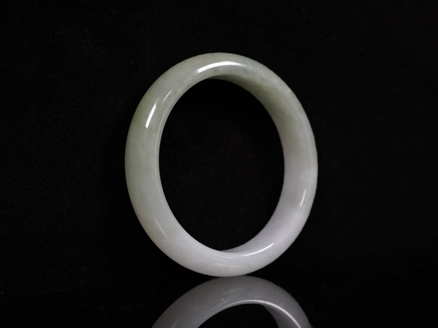 A half white half pale green dual tone  jadeite bangle.