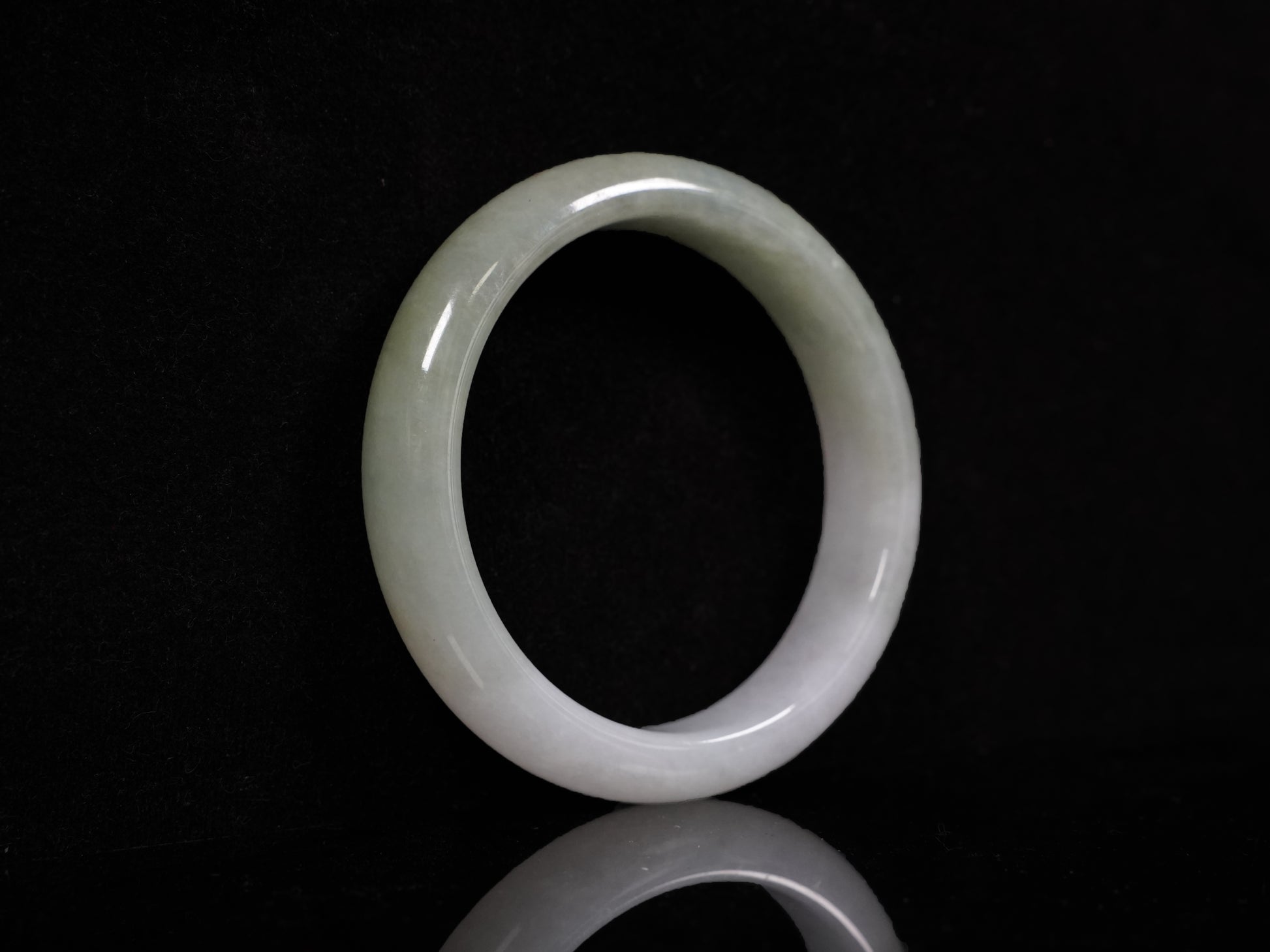 A half white half pale green dual tone  jadeite bangle.