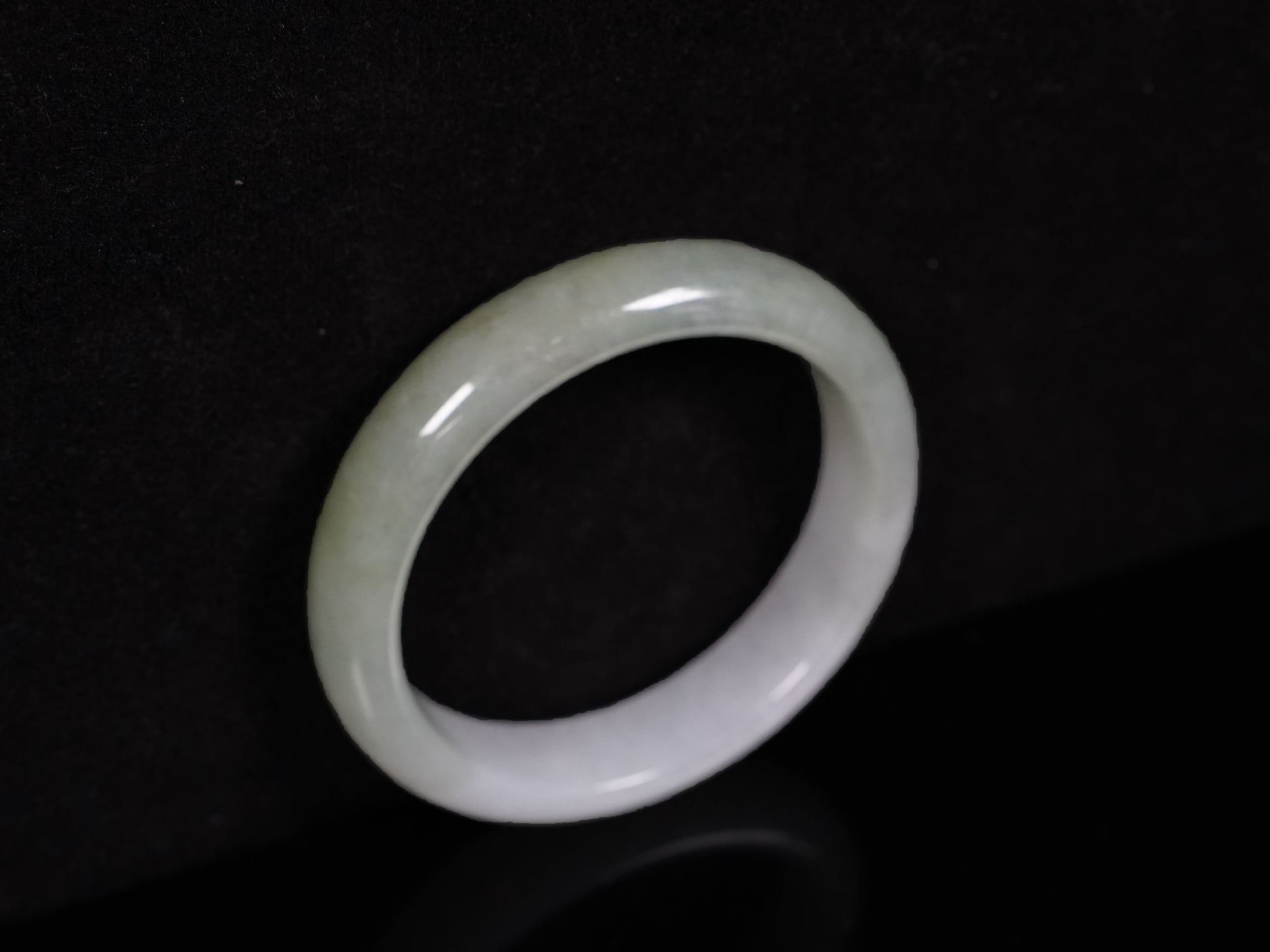 A half white half pale green dual tone  jadeite bangle.